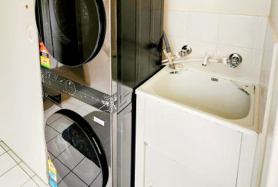 The laundry at 1-20 Flinders Parade, Victor Harbor with new washing machine, dryer, tub and ironing facilities at Waimea, holiday rental townhouse .